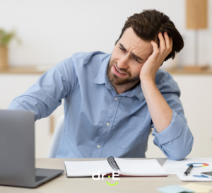 Man sitting at desk despondent